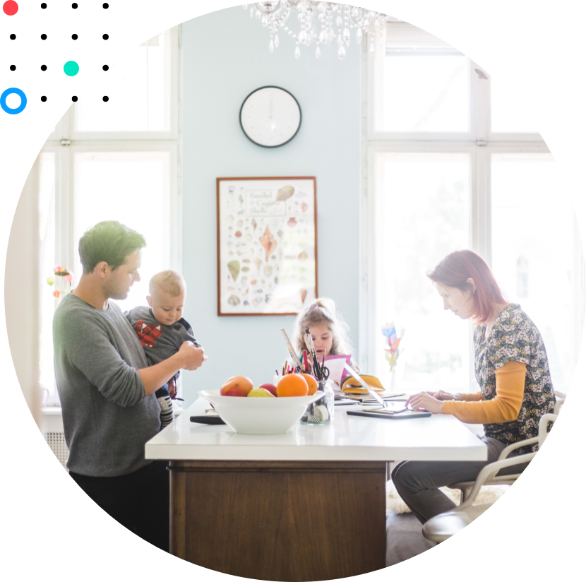 Image of young family at their kitchen island, mom is at work and dad is helping children with school.